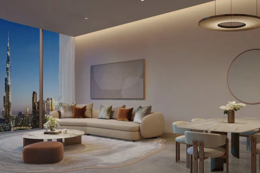 Living and dining room at dusk with curved glass facing Burj Khalifa